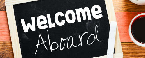 Welcome aboard sign with coffee